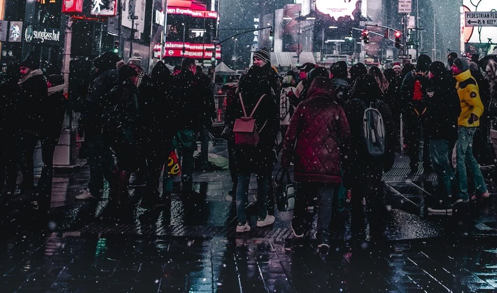 A group of people shopping at night in New York City